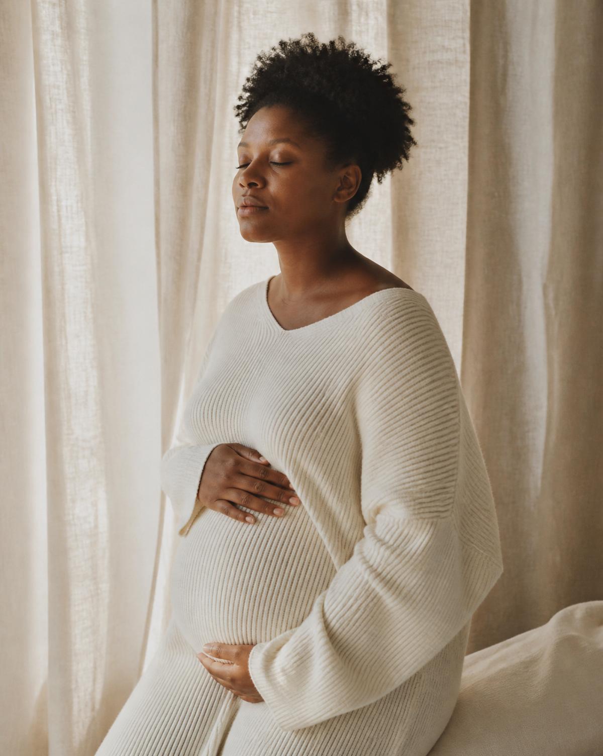 A pregnant woman in soft, natural light